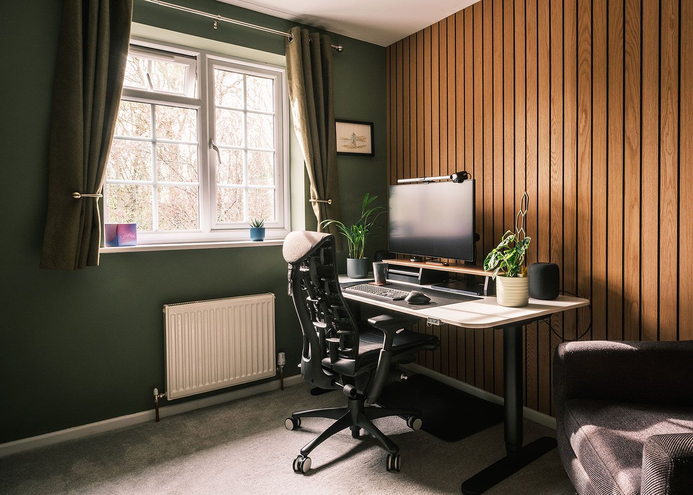 Photo showing my desk against a wood panelled wall